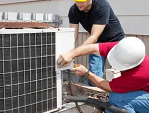 HVAC technicians repairing an outdoor AC unit on a rooftop in Redmond, WA